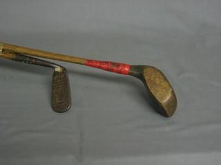 A hickory shafted gold driver and a do. putter