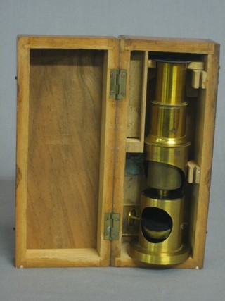 A 19th Century brass single pillar student's microscope contained in a wooden box