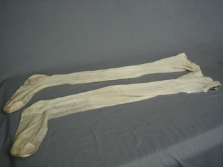 A pair of Queen Victoria's white silk stockings, the top with crown and VR cypher