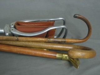 A metal framed shooting stick and a bundle of various sticks