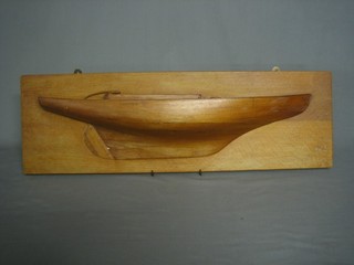 A wooden half hull model of a yacht 29"