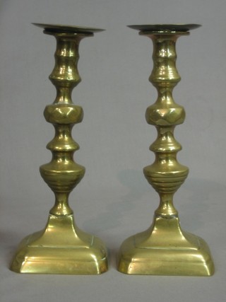 A pair of 19th Century brass candlesticks with detachable sconces