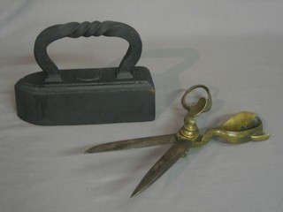 A large pair of tailors brass and polished steel cloth shears and a large flat iron