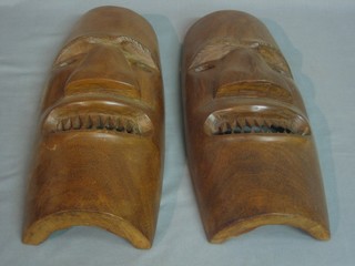 A pair of African carved wooden masks 16"