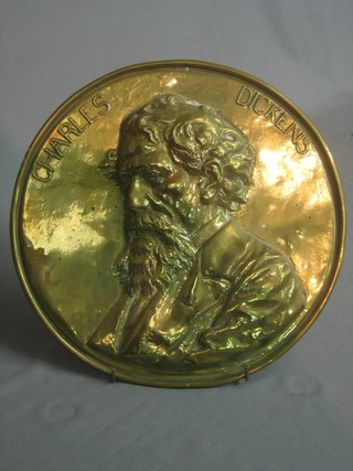 A embossed brass plaque of a head and shoulders portrait of Charles Dickens 11"