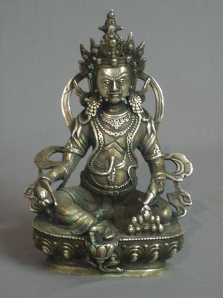 An Eastern silver coloured metal figure of a seated Deity 8 1/2"