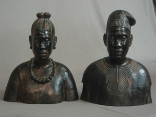 A pair of African carved wooden portrait busts of a lady and gentleman, the bases marked by Jo Ogunbohlda Owa 11"
