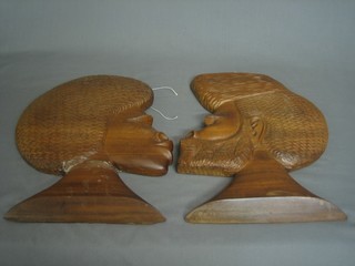 A pair of African carved hardwood wall plaques in the form of heads 14"