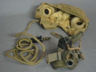 A canvas flying helmet complete with ear phones and oxygen mask, ear phones marked AM10A/13466, oxygen marked AM10A-12570