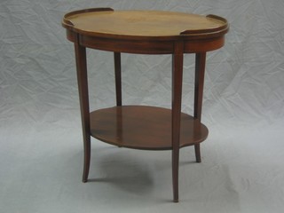 An Edwardian oval mahogany 2 tier etagere, raised on outswept supports 25"