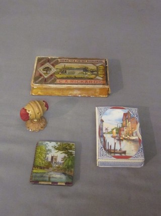 A Victorian carved ivory double sided pin cushion 2", a Victorian glass needle case decorated St Johns Chapel and College Cambridge, a set of Rickards darning silks and an unopened set of De La Rue playing cards