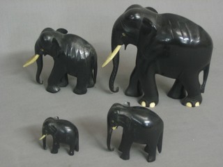 4 graduated ebony and ivory elephants