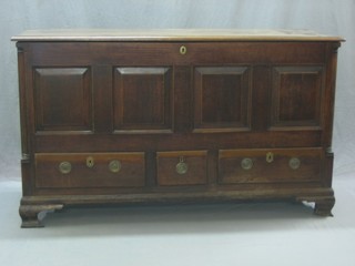 An 18th Century mule chest of panelled construction with later hinged lid, the base fitted 2 long drawers raised on ogee bracket feet 60"