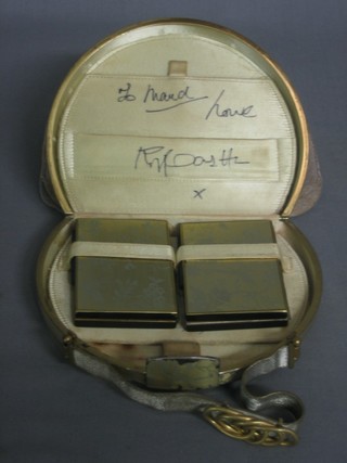 A lady's 1950's oval metal evening bag containing 2 rectangular compacts, the interior signed by Roy Castle and bears 1 other signature