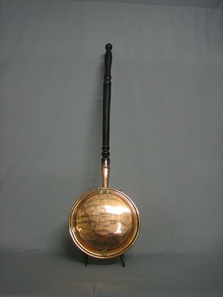 A 19th Century copper warming pan with turned ebony handle