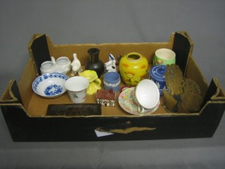 A Jasperware style cylindrical jar and cover, a quantity of decorative ceramics including a plaster plaque, a pair of pierced metal sconces etc