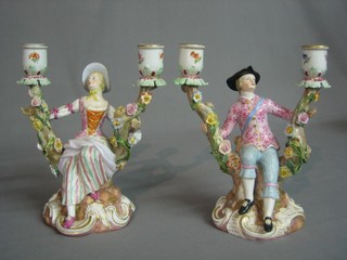 A handsome pair of 19th Century "Meissen" porcelain twin handled candelabrum supports by a lady and gentleman, the base with crossed swords mark impressed 72 763 and incised 1129 8" (sconce to gentleman candelabrum f and r)