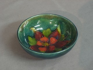 A Moorcroft circular green glazed bowl decorated an anemone, the base impressed Moorcroft Made in England 3 1/2" (slight chip to base) 