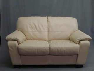 A 3 piece suite upholstered in white hide comprising 2 seat settee 58" and 2 matching armchairs