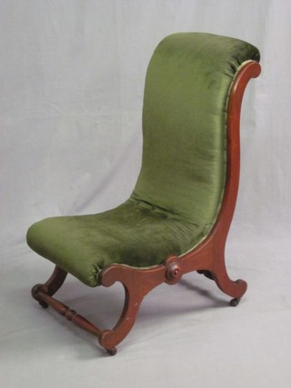 A Victorian mahogany show frame nursing chair upholstered in green material