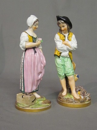 A pair of 19th Century Continental porcelain figures in the form of a standing lady and gentleman 9"