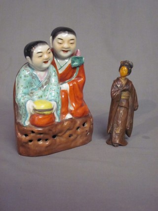 An Oriental porcelain figure in the form of a lady and gentleman 8" and a metal figure of a standing Geisha girl 6"
