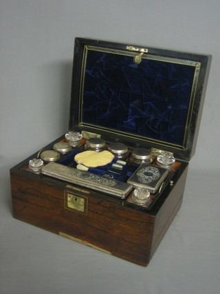A Victorian rosewood vanity box with hinged lid the interior fitted glass bottles with plated mounts 12"