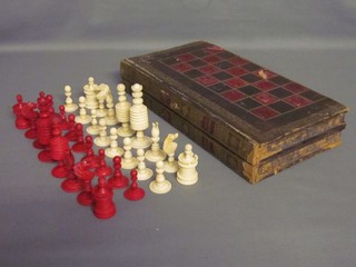 A white and red ivory chess set contained a leather box incorporating backgammon and chess