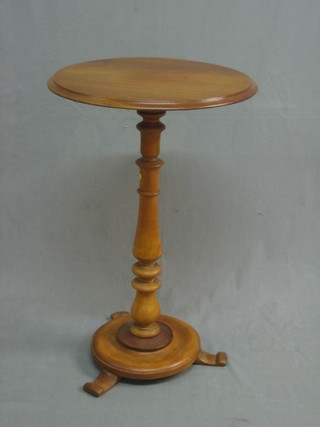 A circular bleached mahogany wine table, raised on a turned column 19"