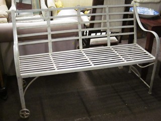 A 19th Century style railed iron bench, raised on wheels 59"