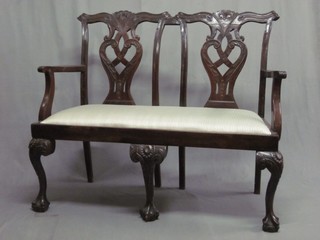 A Chippendale style double chair back settee with upholstered drop in seat, raised on cabriole ball and claw supports 45"