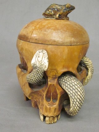 An Eastern carved hardwood jar and cover in the form of a human skull with carved ivory Cobra 5"