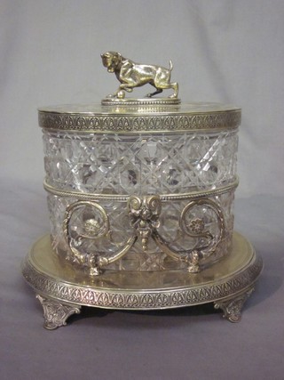 A handsome Victorian oval cut glass biscuit barrel with silver plated mounts, the finial on the lid in the form of a dog with ball, 8"