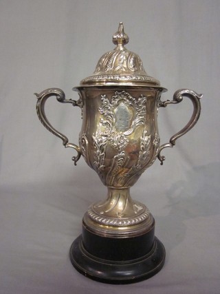 A George III embossed silver twin handled cup and cover with embossed body by John Swift 1766, inscribed The Gift of the Owner of the Ship Caroline to Captain And Candle anno 1766, 45 ozs