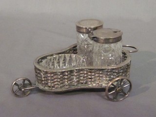 A 3 piece cut glass cruet with silver plated mounts contained in a silver plated basket work cruet frame