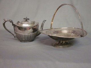 An oval embossed Britannia metal teapot and an oval silver plated cake basket with swing handle