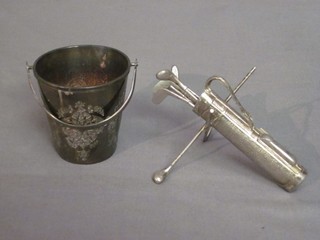 A set of 6 silver plated pickle forks in the form of golf clubs contained in a golf bag and a silver plated pail