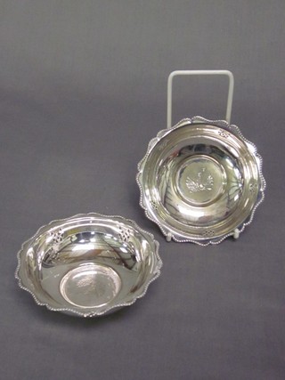 A pair of circular silver plated dishes with beadwork borders, decorated the Arms of The HAC