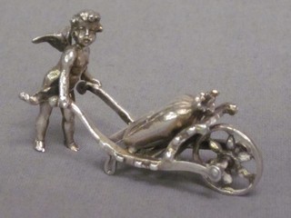A Continental silver figure of a cherub with handcart and sack 2"