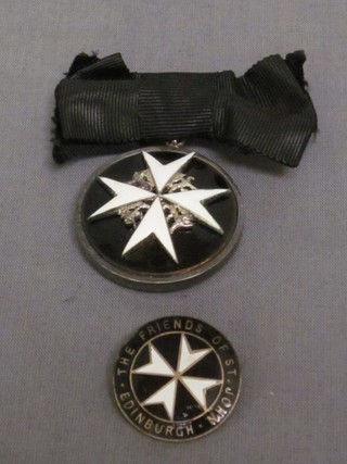 A breast badge of a Serving Sister of the Most Venerable Order of St John of Jerusalem and an enamelled The Friends of St John Edinburgh badge