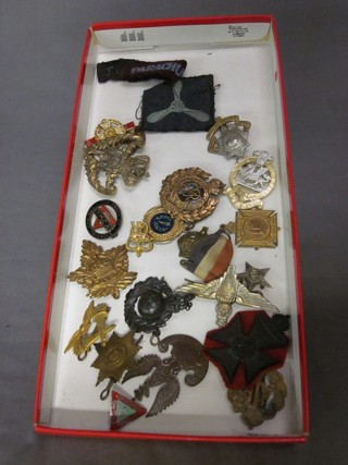 An Irish Guards cap badge, a Parachute Regt. cap badge, a Royal Marines cap badge and other various cap badges
