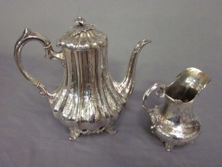 A Victorian engraved silver plated coffee pot and a do. cream jug