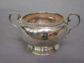 A circular twin handled sugar bowl, Birmingham 1929, raised on a circular spreading foot 6 ozs