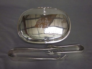 An oval silver plated dish with armorial decoration and 2 pairs of silver plated ice tongs