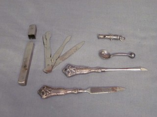 A whistle in the form of a canon barrel, 2 silver handled manicure items and a travelling manicure set