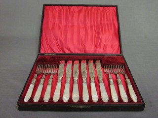 A set of 6 Victorian silver plated fruit knives and forks with carved mother of pearl handles, cased