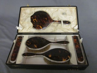 A 5 piece silver and tortoiseshell backed dressing table set, Birmingham 1922, cased