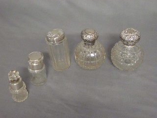 A faceted cut glass pin jar with silver lid, 2 globular glass scent bottles and stoppers and 2 other scent/dressing table bottles