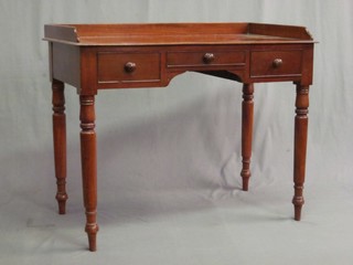 A Victorian mahogany wash stand with three-quarter gallery, the base fitted 1 long and 2 short drawers, raised on turned supports 40"