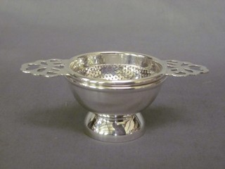 A modern silver plated tea strainer 